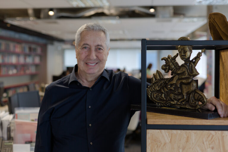 Paulo Rocco ao lado da estátua recebida por acabar com impostos para as editoras